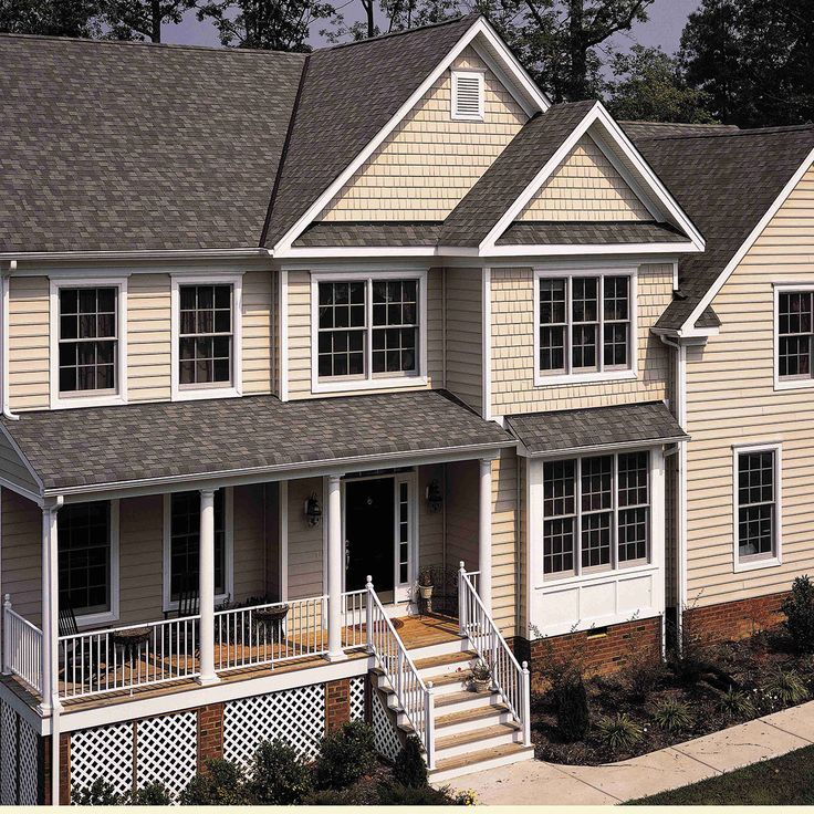 a large house with two story windows and white shutters on the second floor is shown