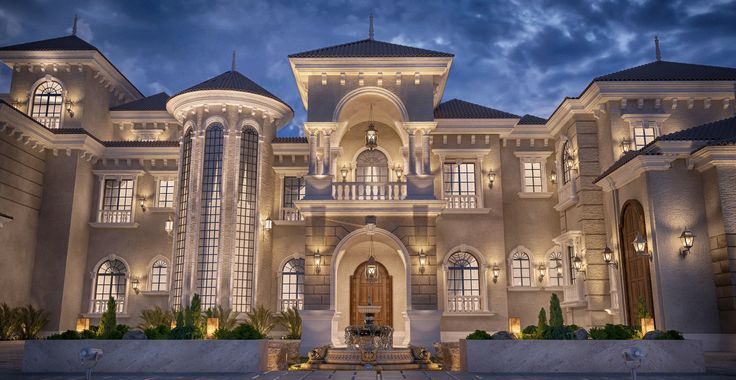 a large white building with lots of windows and lights on it's front entrance