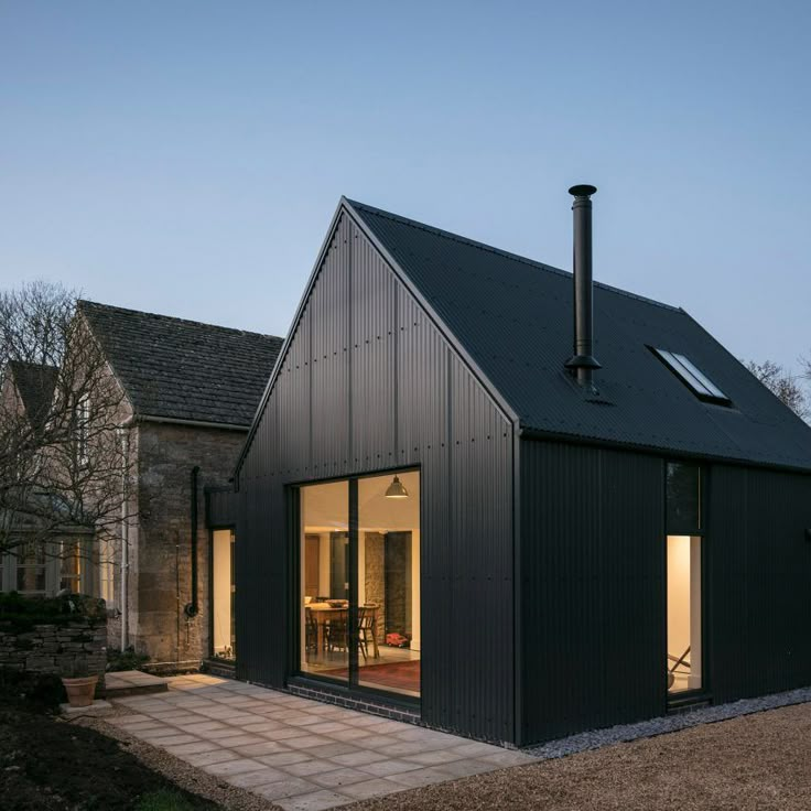 a black house with large windows on the side