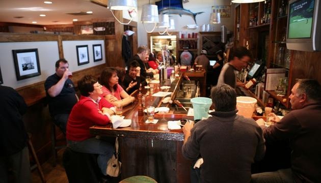 a group of people sitting at a bar