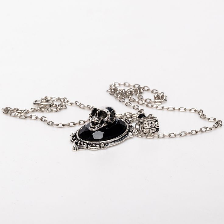 Crafted from stained alloy stainless steel, our Victorian skull necklace is a striking piece. Measuring 20 inches in length, it features a 1 by 1.5-inch skull pendant, perfect for adding a touch of gothic elegance to any Gothic Black Alloy Necklaces, Black Gothic Alloy Necklaces, Gothic Silver Jewelry With Skull Print, Halloween Skull Chain Jewelry, Gothic Stainless Steel Necklace With Adjustable Chain, Nickel Free Black Alloy Necklaces, Nickel Free Black Alloy Necklace, Nickel-free Black Alloy Necklace, Gothic Alloy Chain Necklace