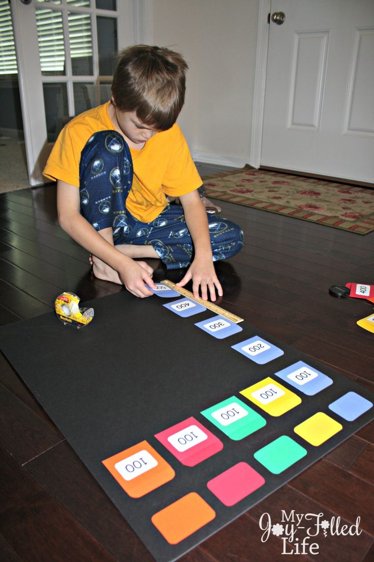 a young boy is playing with a board game