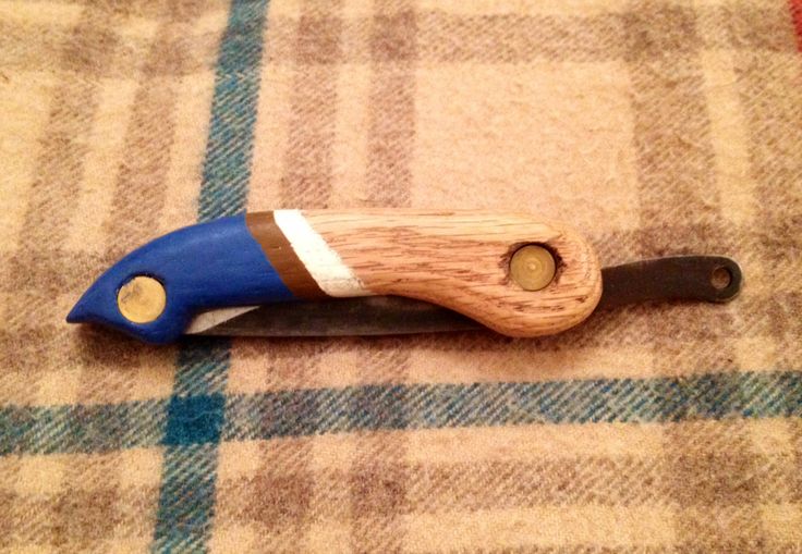 a blue and white wooden handle on a plaid cloth