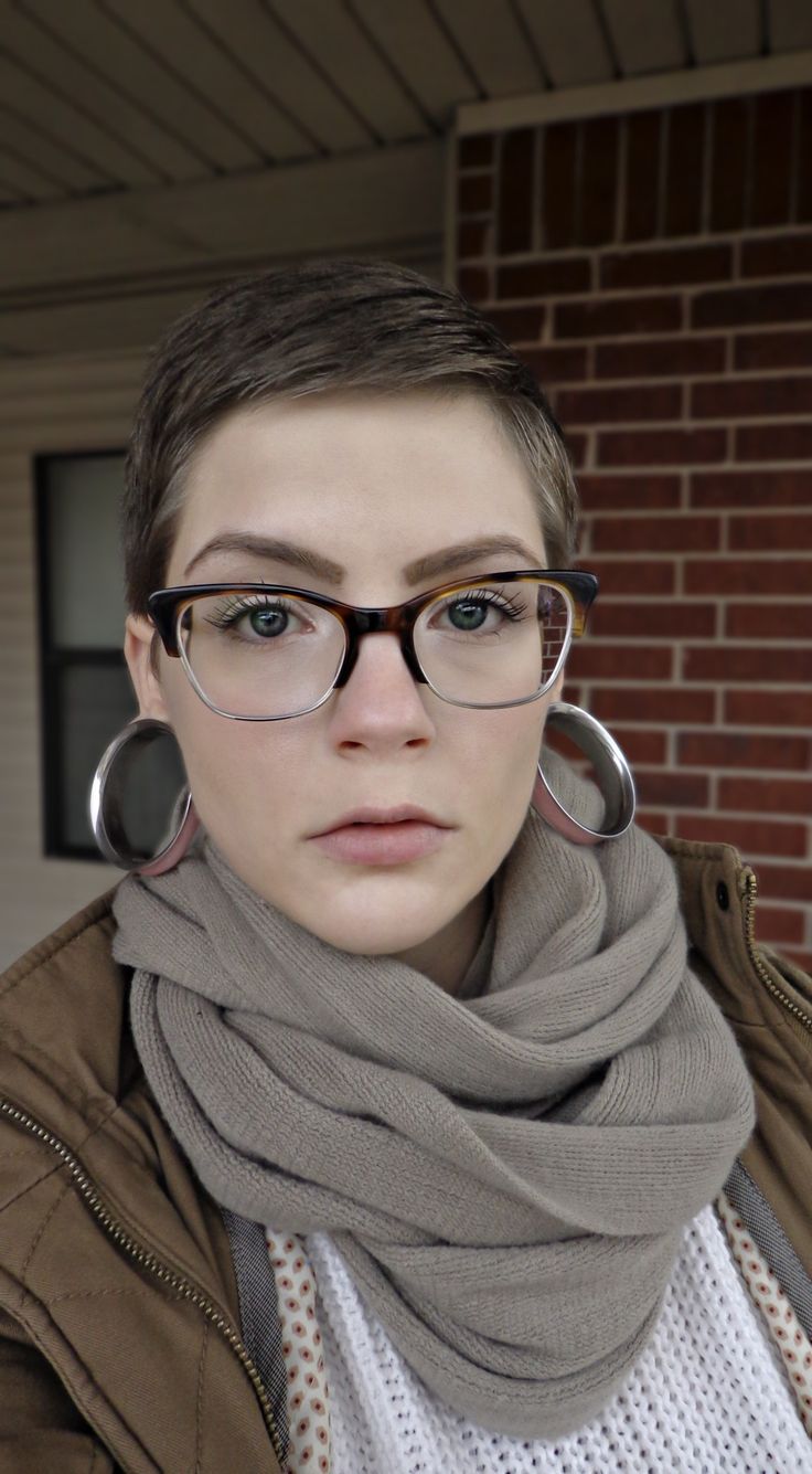 a woman wearing glasses and a scarf around her neck