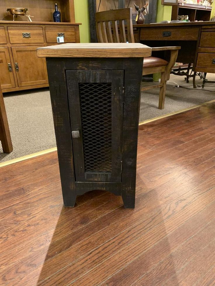 a wooden cabinet sitting on top of a hard wood floor