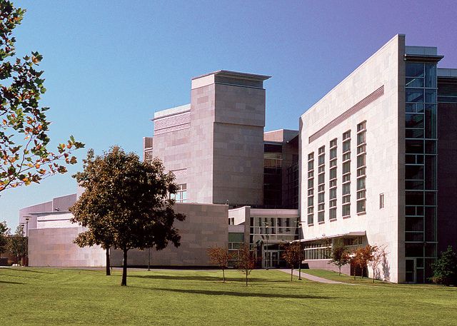 a large building sitting on top of a lush green field