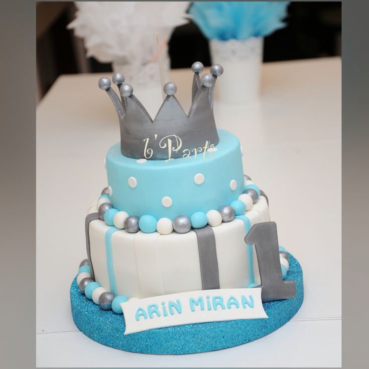 a blue and white cake with a crown on top