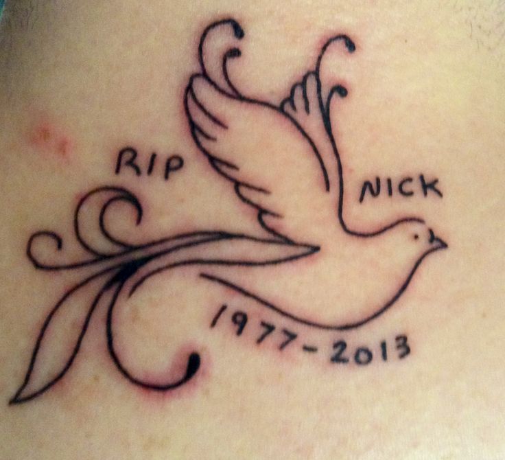 a tattoo on the back of a woman's neck with a dove and date