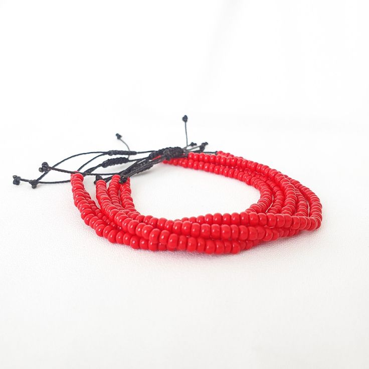 "RED Beaded Minimal Cord Bracelet * Size 6-7 Inches * Opaque Red Bead Bracelet * Red Seed Bead Bracelet * RED String Bracelet * Red Bracelet This is a minimal bracelet, A lightweight & delicate bracelet and perfect for everyday wear.  Perfect as Birthday, Christmas and Friendship presents. The bracelet will fit wrist size 6 to 7 inches. Please note this bracelet is not sterling silver.  If you have any questions about the bracelet, contact me through the \"Etsy conversation system\". PLEASE NOTE: COLOR OF ITEM MAY APPEAR SLIGHTLY DIFFERENT IN REAL LIFE FROM PICTURES ABOVE DUE TO LIGHTING. Package contents: 1  RED Seed Bead Adjustable Cord Bracelet - Size of bead size is 8/0  Care Instructions: We advise that you keep your item dry at all times and away from perfume, hairspray and body crea Spiritual Red Friendship Bracelets With Round Beads, Red Spiritual Bracelets With 108 Beads, Red Spiritual Bracelet With 108 Beads, Adjustable Red Coral Beaded Bracelets, Adjustable Red Coral Beaded Bracelets With Round Beads, Adjustable Red Coral Beaded Bracelet, Red Coral Beaded Bracelets With Round Beads, Red Beaded Coral Bracelets, Red Coral Beaded Bracelets