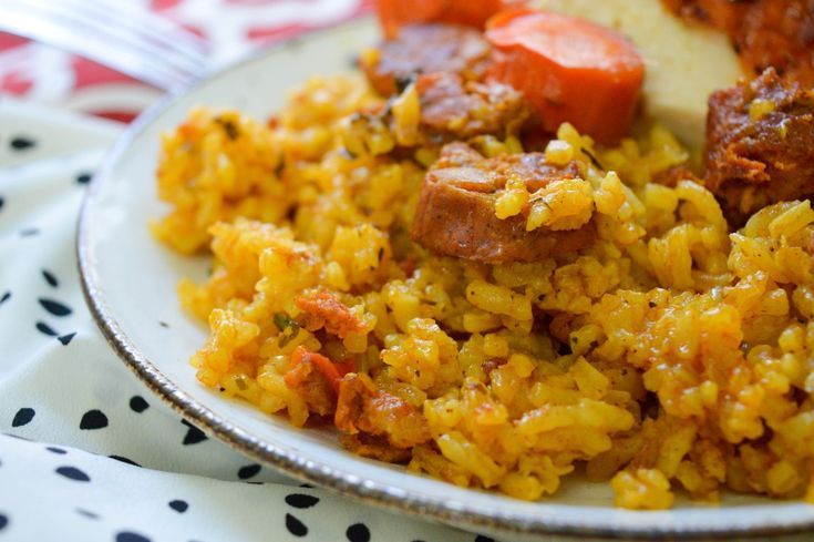 a white plate topped with rice and meat