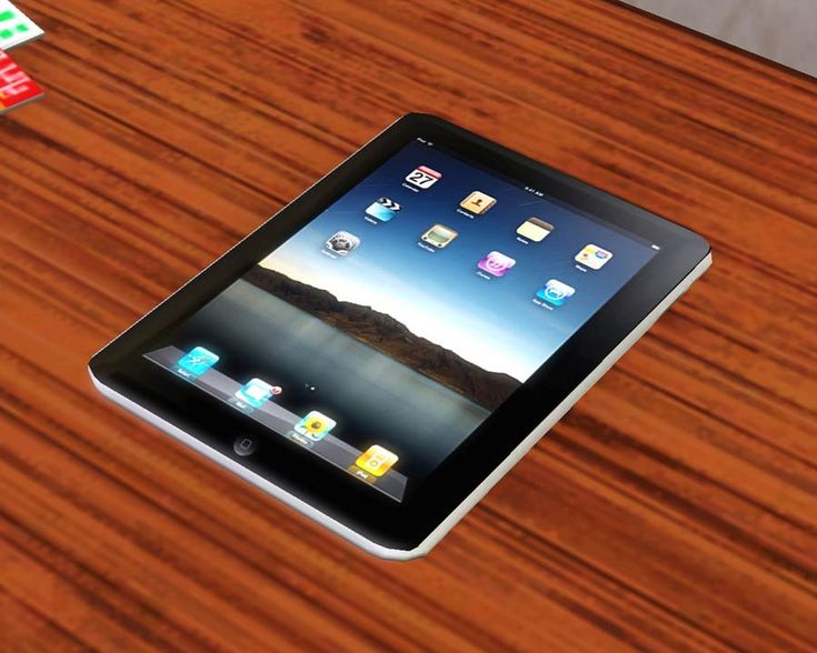 an ipad sitting on top of a wooden table