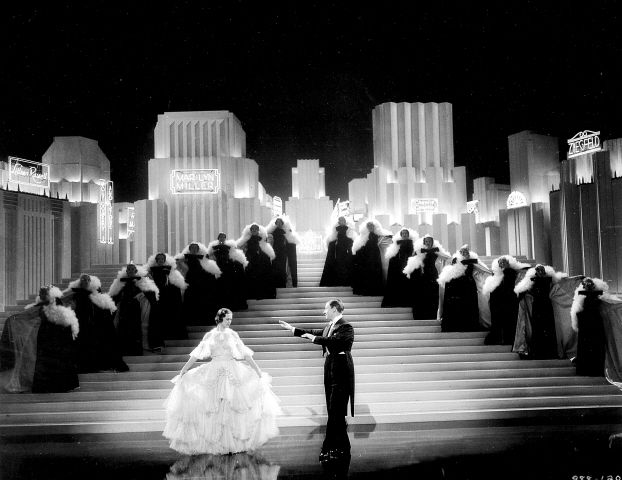 black and white photo of bride and groom on stage