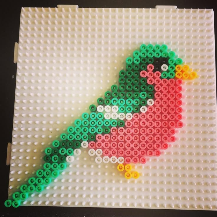 a bird made out of legos sitting on top of a table