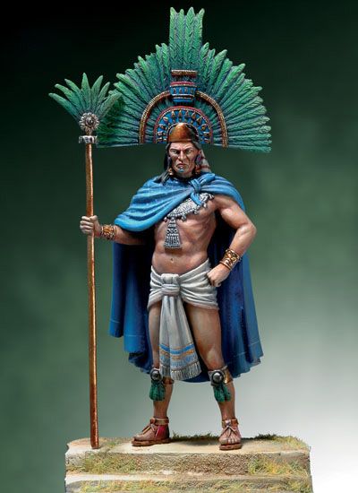 a statue of a man with a spear and headdress