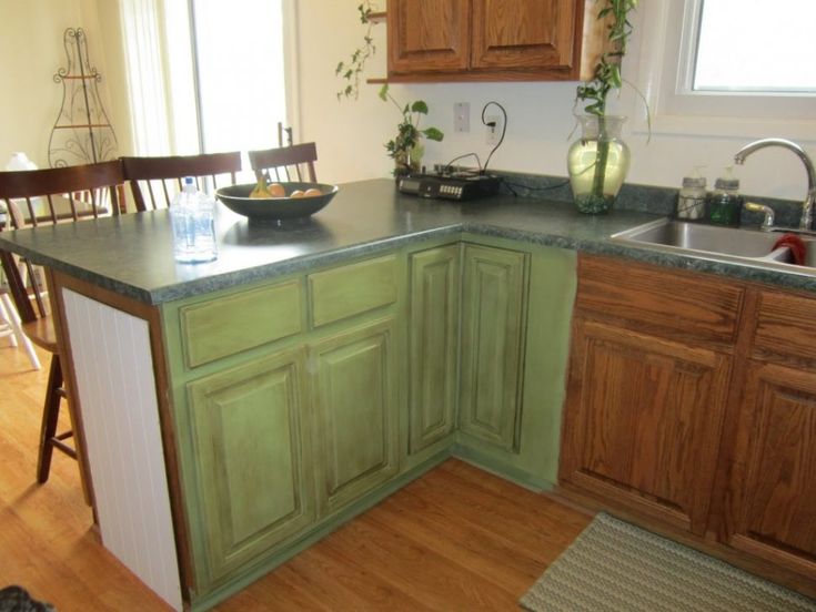 a kitchen with wooden floors and green cabinets