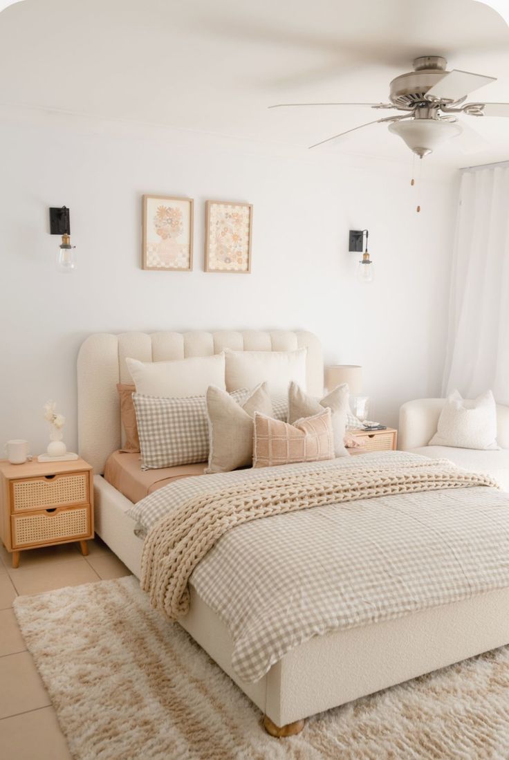 a bedroom with a bed, dresser and ceiling fan