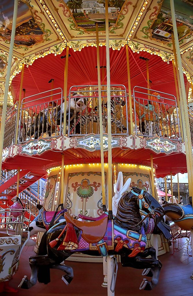 a merry go round with horses and people on it