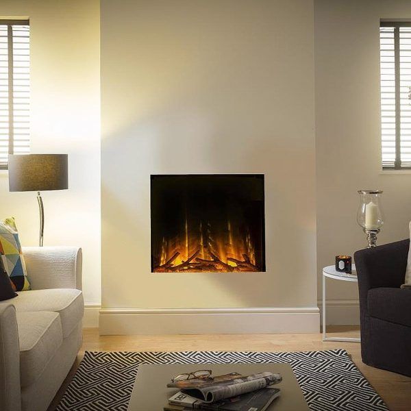 a living room with a couch, chair and fire place on the wall in front of it