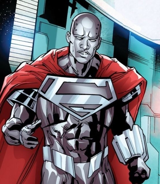 a man in a superman suit with his hands on his hips, standing next to a building