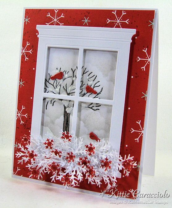 a red and white christmas card with snowflakes on the window sill that has a tree in it