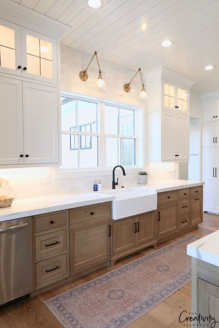 a large kitchen with wooden cabinets and white counter tops, along with a rug on the floor