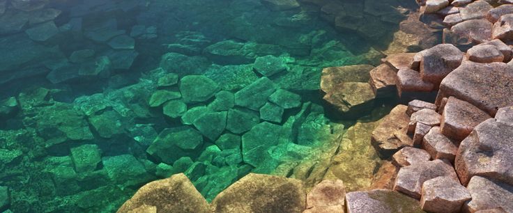 an aerial view of rocks and water with the words, production manager ann brizz