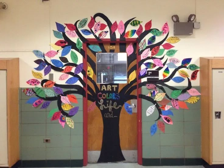 a tree with colorful leaves on it in the middle of a school gym room,