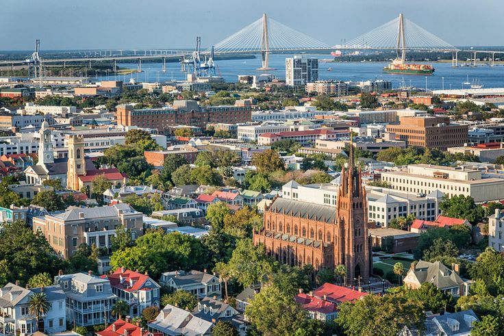 an aerial view of a city with a bridge in the background