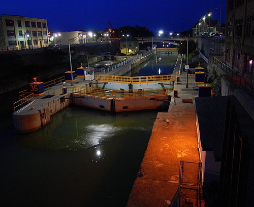 two boats are docked in the water at night