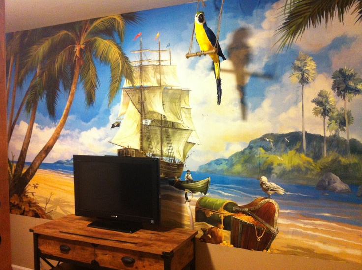 a tv sitting on top of a wooden table in front of a painting wall with birds flying over it