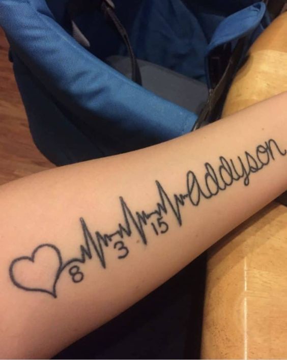 a person with a heartbeat tattoo on their arm