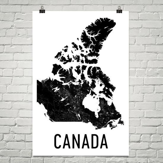 a black and white map of canada with the word canada on it in front of a brick wall