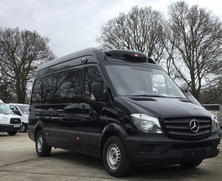 a black mercedes van parked in a parking lot