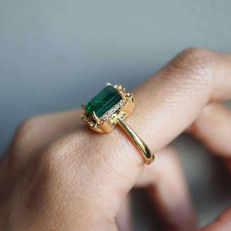 Read about our payment plans before proceeding.The Isis Emerald Scroll Diamond ring is an exquisite piece. Inspired by the details on architectural buildings in NYC, this ring features a stunning natural emerald framed by two baguette diamonds and round diamonds. Made for a true goddess with a touch of vintage vibe. Available in 14K solid yellow gold, white gold, and rose gold. 14K solid gold Natural 9*7mm emerald. Approx. 2.6ct. Comes with a certificate Natural baguette diamonds. Approx. 0.04ct Rings 2023, Ring Inspo, Baguette Diamonds, Wedding Rings Vintage, 18k Gold Ring, Architectural Details, Baguette Diamond, Natural Emerald, Antique Rings