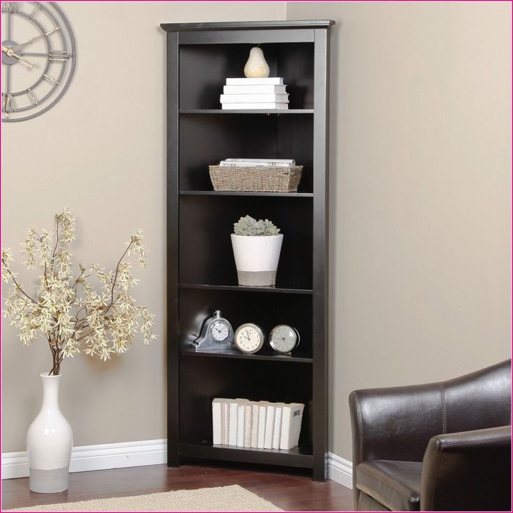 a living room with a black bookcase and white flowers