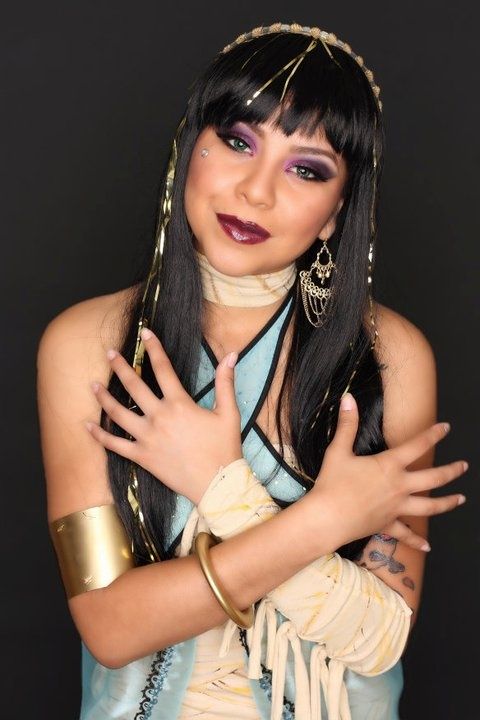 a woman with long black hair wearing a costume