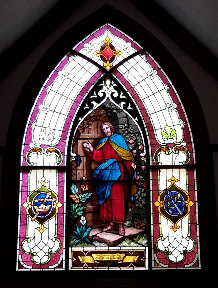 a stained glass window with the image of jesus on it