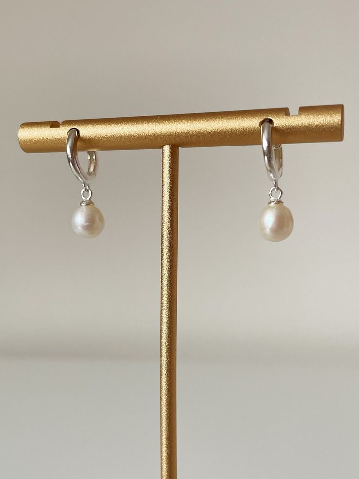 Hey lovely Etsy shopper!  Do you love these beautiful Sterling Silver Freshwater Pearl Huggies? Beautifully detailed!  Simple and elegant design. Hoop is just 10mm small making them so classy, would make a perfect understated bridal earring, or a perfect simple everyday earring. Happy Shopping! And a big thank you for looking at our beautiful jewellery, if you love our stuff follow us on Instagram @shellseekersjewellery. Classic Huggie Earrings For Wedding, Elegant White Huggie Earrings For Everyday, Elegant Nickel-free Dangle Huggie Earrings, Elegant Everyday Nickel-free Huggie Earrings, Elegant White Teardrop Huggie Earrings, Minimalist Hypoallergenic Huggie Earrings For Wedding, Nickel-free Elegant Huggie Earrings, Dainty Hypoallergenic Huggie Earrings For Wedding, Delicate Hypoallergenic Huggie Earrings For Wedding