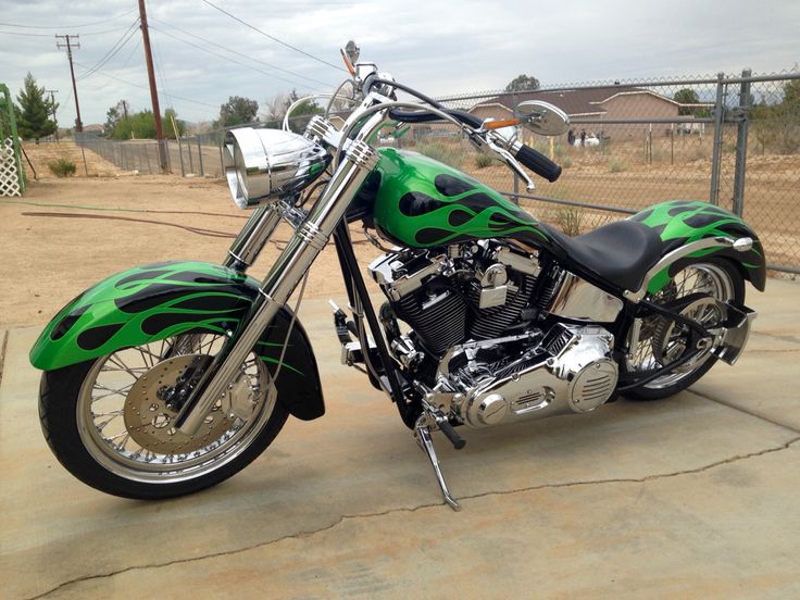 a green and black motorcycle parked on the street