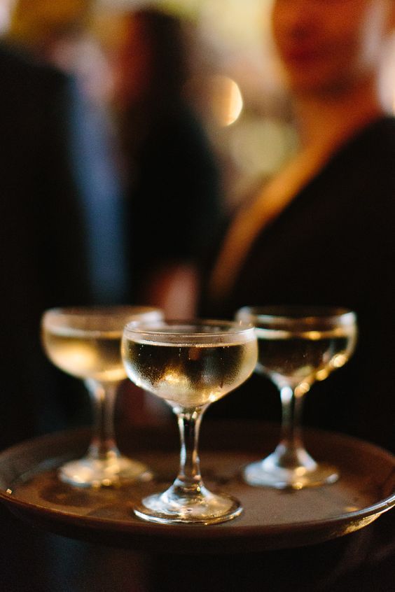 three wine glasses sitting on top of a tray