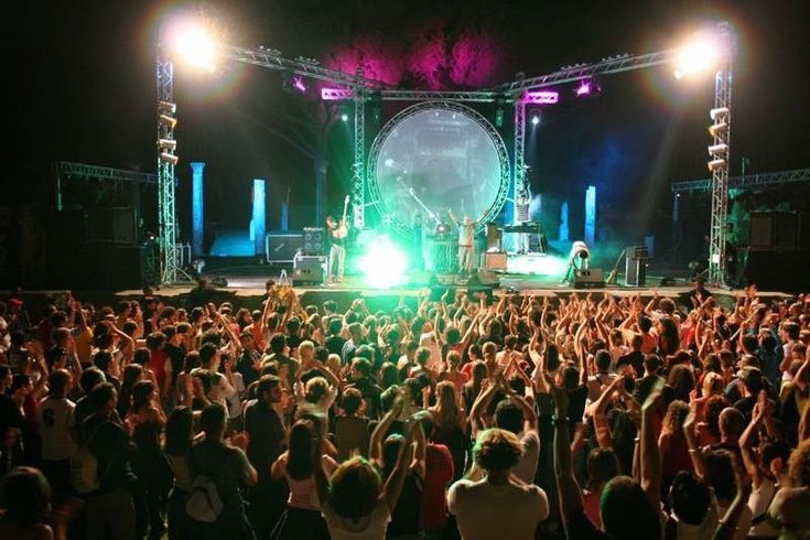 a large group of people standing on top of a stage