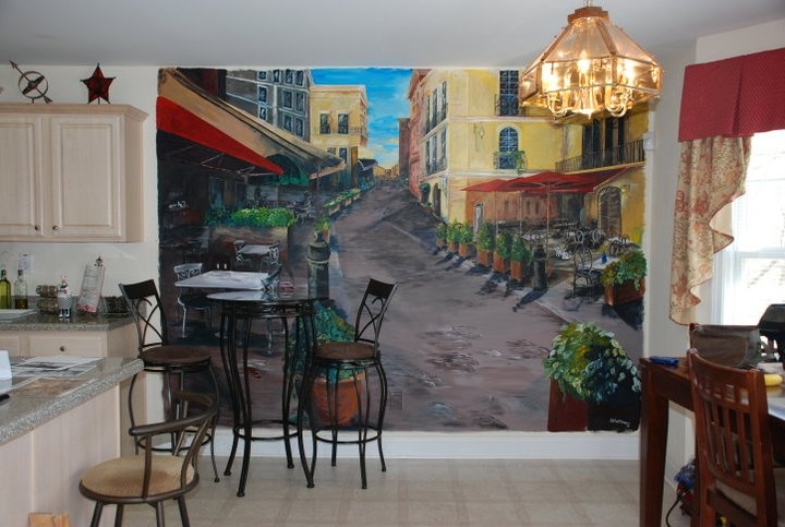 a kitchen with a large mural on the wall