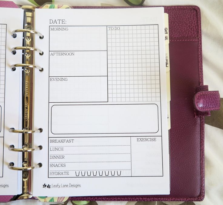 an open planner book on top of a bed