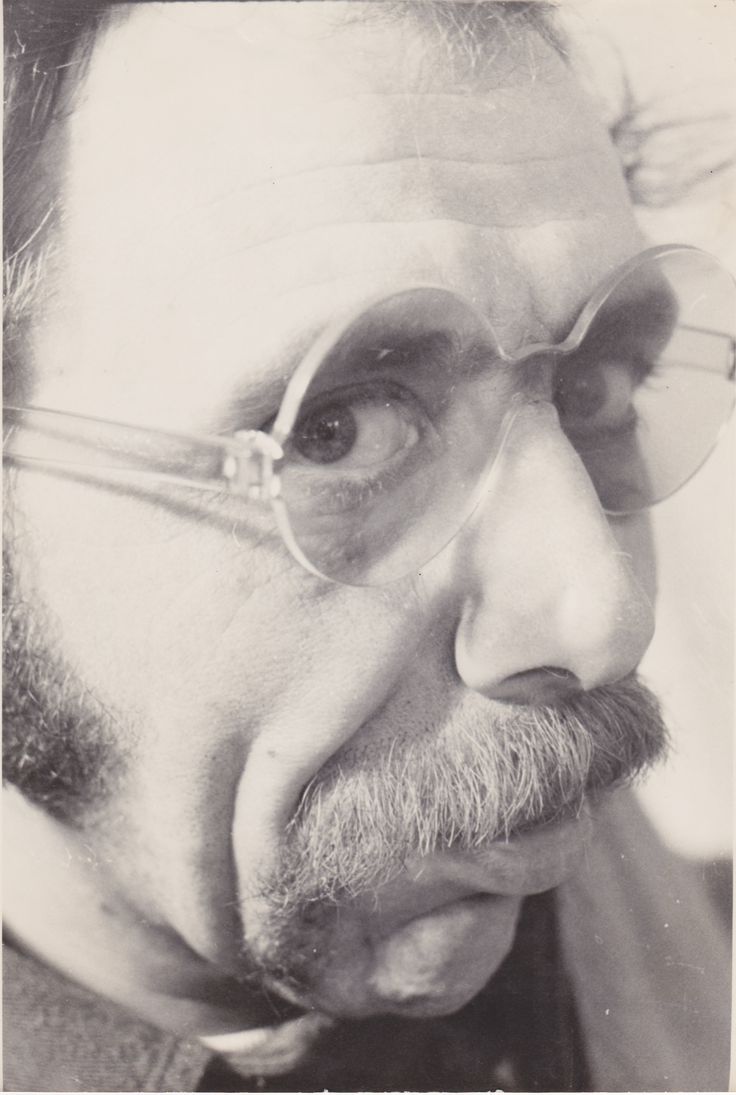 an old black and white photo of a man with glasses