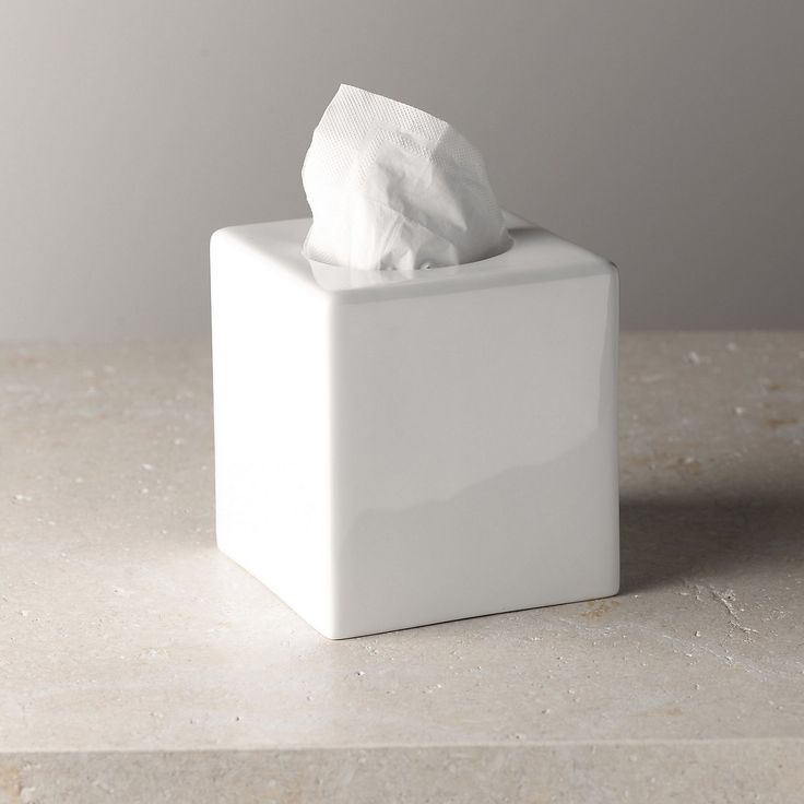 a white tissue dispenser sitting on top of a counter