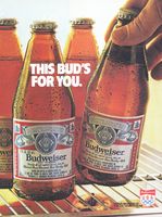 an advertisement for budweiser beer is shown in front of several bottles on the shelf