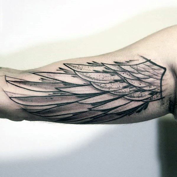 a man's arm with an angel wing tattoo on it, in black and white