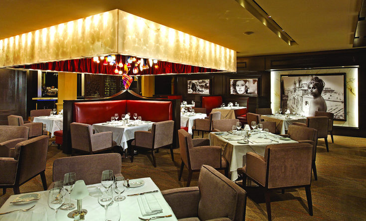 a restaurant with tables and chairs set up for dinner