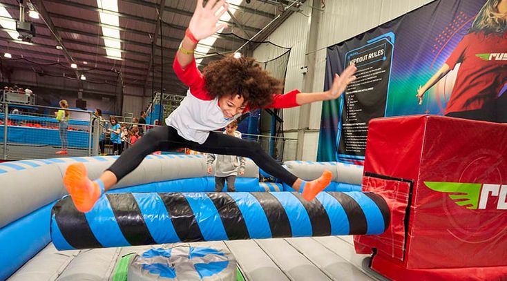 a man is jumping on an inflatable trampoline