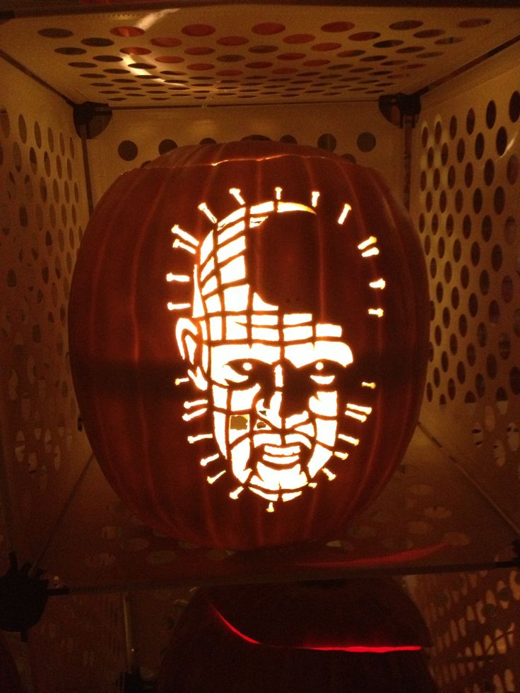 a pumpkin carved to look like the face of abraham lincoln is lit up at night